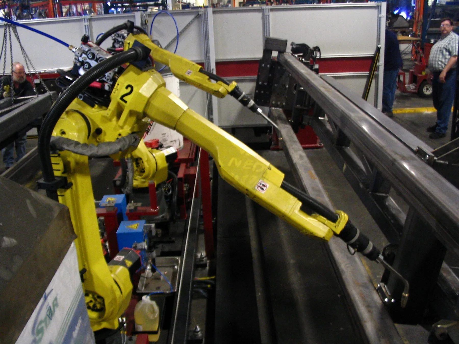 Industrial technician inspecting CNC machinery and spare parts in a service environment